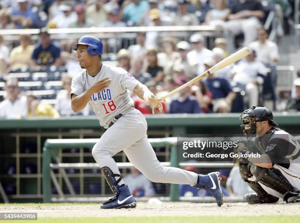 Moises Alou of the Chicago Cubs bats against the Pittsburgh Pirates as catcher Jason Kendall of the Pirates looks on during a game at PNC Park on...