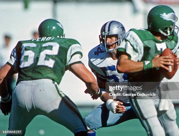Defensive lineman Randy White of the Dallas Cowboys looks across the line of scrimmage at guard Petey Perot of the Philadelphia Eagles as quarterback...