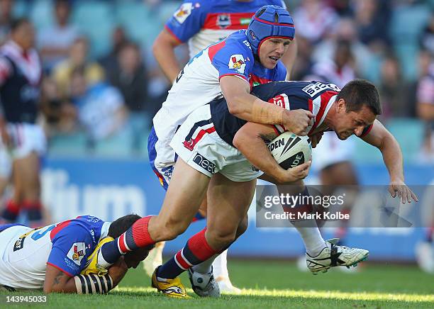 Mitchell Pearce of the Roosters is tackled during the round nine NRL match between the Sydney Roosters and the Newcastle Knights at Allianz Stadium...