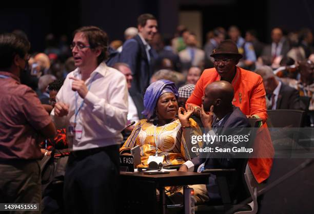 Delegates chat as they arrive in the plenary hall on the first day of the UNFCCC COP27 climate conference on November 06, 2022 in Sharm El Sheikh,...