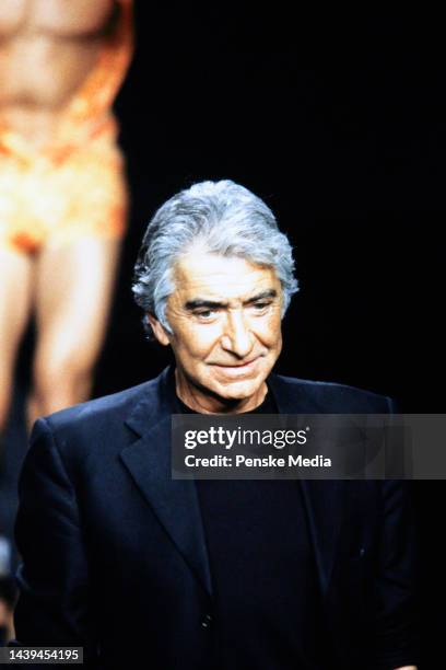 Designer Roberto Cavalli walks the runway at show finale.