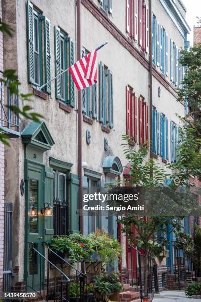 row houses with american flag - philadelphia townhouse homes stock pictures, royalty-free photos & images