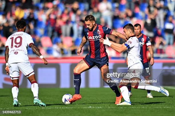 Marko Arnautovic of Bologna FC competes for the ball with Alessandro Buongiorno of Torino FC during the Serie A match between Bologna FC and Torino...