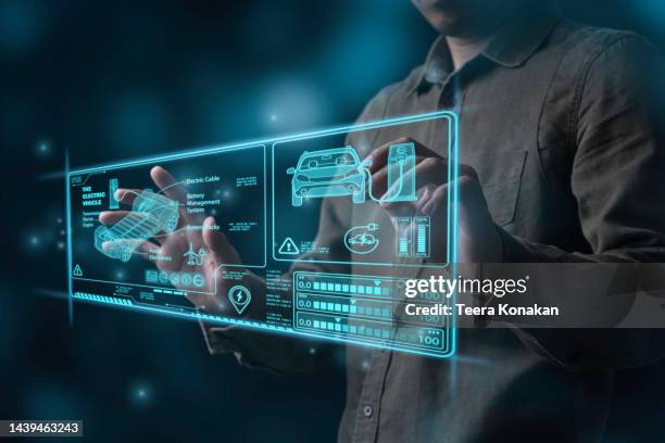 the engineer points to a virtual screen to show the design, manufacturing and clean energy concepts of electric vehicles, which are generated from the automotive field. future electric vehicle - results show stockfoto's en -beelden