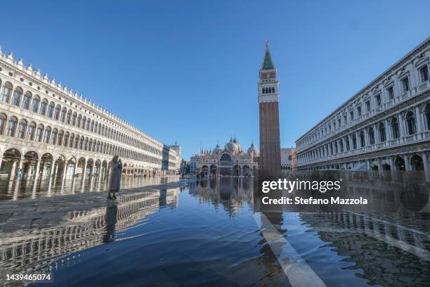 Tourist photographs St. Mark's Square flooded by high tide on November 06, 2022 in Venice, Italy.