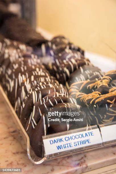 dark chocolate dark stripe covered pretzels - brezel stock-fotos und bilder