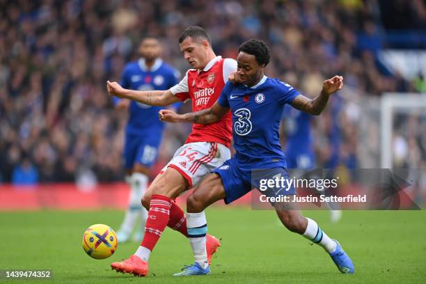 Granit Xhaka of Arsenal battles for possession with Raheem Sterling of Chelsea during the Premier League match between Chelsea FC and Arsenal FC at...