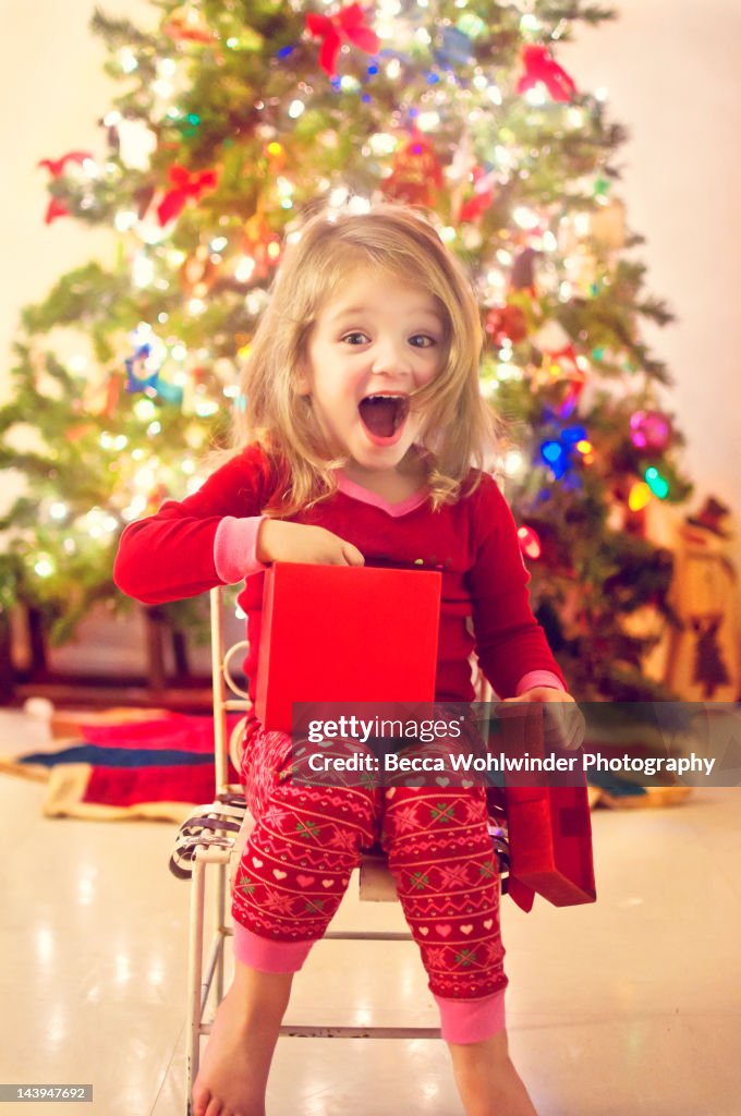 Girl surprised after opening Christmas gift