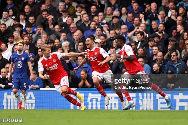 William Saliba celebrates with Martin Oedegaard and Bukayo Saka after Gabriel of Arsenal scored their sides first goal during the Premier League...