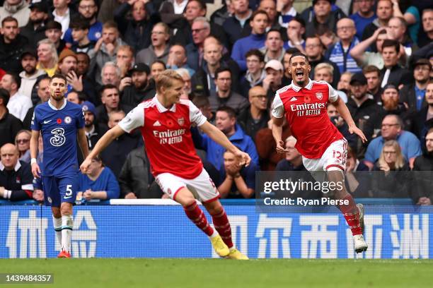 William Saliba celebrates with Martin Oedegaard after Gabriel of Arsenal scored their sides first goal during the Premier League match between...