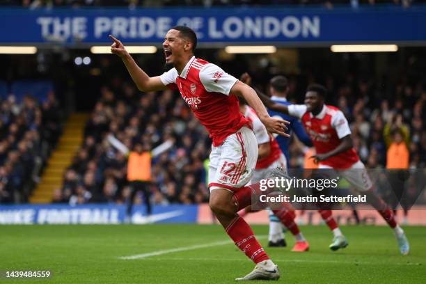 William Saliba celebrates after Gabriel of Arsenal scored their sides first goal during the Premier League match between Chelsea FC and Arsenal FC at...