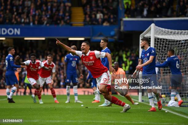 William Saliba celebrates after Gabriel of Arsenal scored their sides first goal during the Premier League match between Chelsea FC and Arsenal FC at...