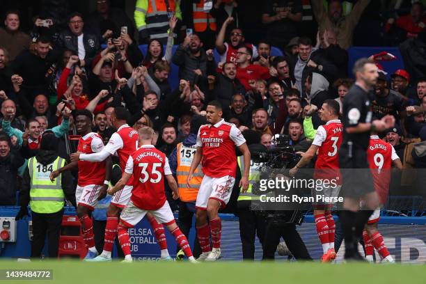 William Saliba celebrates after Gabriel of Arsenal scored their sides first goal during the Premier League match between Chelsea FC and Arsenal FC at...
