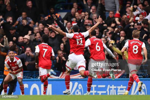 Gabriel of Arsenal celebrates with teammates after scoring their team's first goal during the Premier League match between Chelsea FC and Arsenal FC...