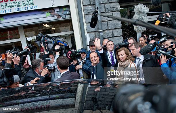 Socialist Party candidate Francois Hollande leaves a polling station with his partner Valerie Trierweiler after casting his vote during the second...