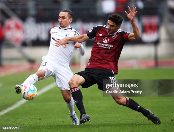 Baris Atik of FC Magdeburg is challenged by Christopher Schindler of FC Nuernbergduring the Second Bundesliga match between 1. FC Nürnberg and 1. FC...