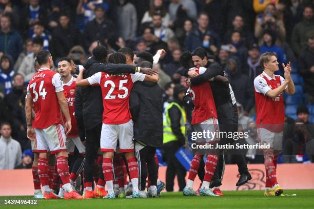 Mikel Arteta celebrates with Thomas Partey of Arsenal after their sides victory during the Premier League match between Chelsea FC and Arsenal FC at...