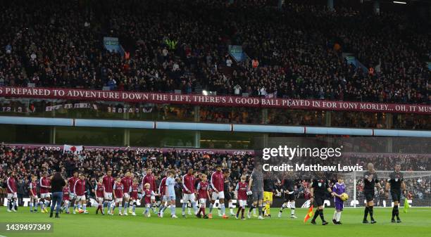 The two teams walk out ahead of the Premier League match between Aston Villa and Manchester United at Villa Park on November 06, 2022 in Birmingham,...