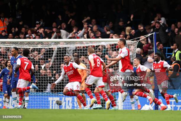 Gabriel of Arsenal celebrates with teammates after scoring their team's first goal during the Premier League match between Chelsea FC and Arsenal FC...