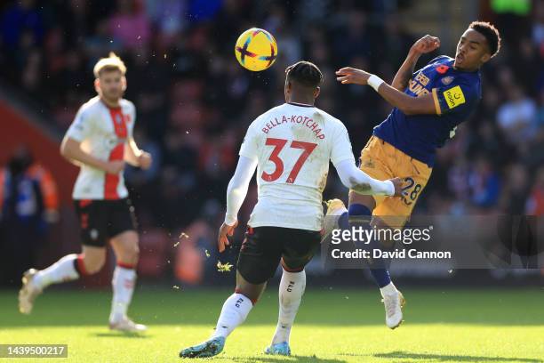 Joe Willock of Newcastle United battles for possession with Armel Bella-Kotchap of Southampton during the Premier League match between Southampton FC...