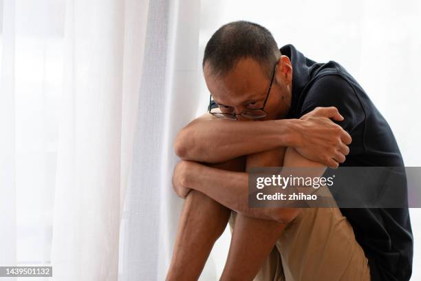 scared asian man - psychopathy stock pictures, royalty-free photos & images