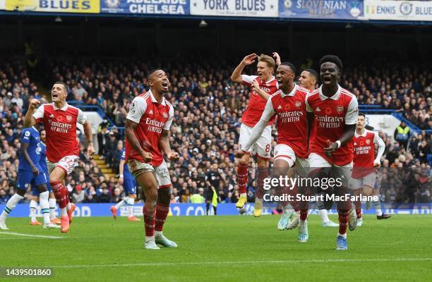 The Arsenal players celebrate their goal, scored by Bukayo Saka during the Premier League match between Chelsea FC and Arsenal FC at Stamford Bridge...