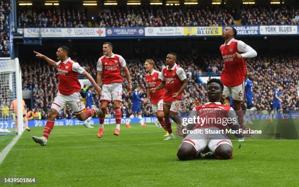 The Arsenal players celebrate their goal, scored by Bukayo Saka during the Premier League match between Chelsea FC and Arsenal FC at Stamford Bridge...