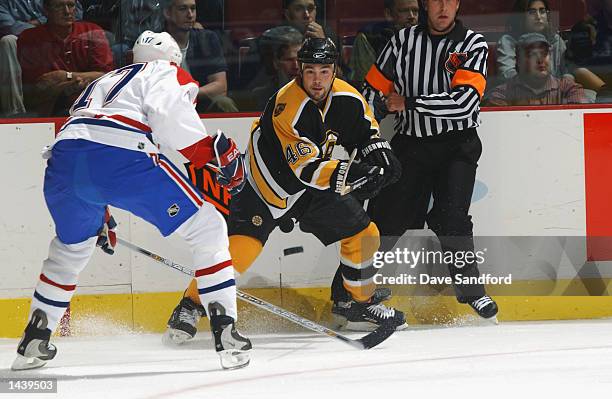September 23: Defenseman Jonathan Girard of the Boston Bruins shoots the puck as right wing Jason Ward of the Montreal Canadiens pressures him during...