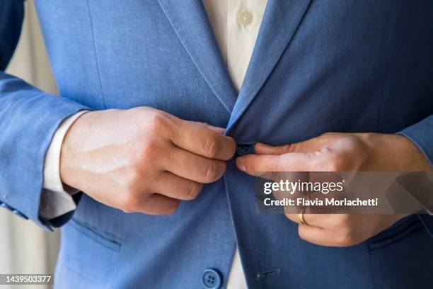 man buttoning the jacket - buttoning stock pictures, royalty-free photos & images