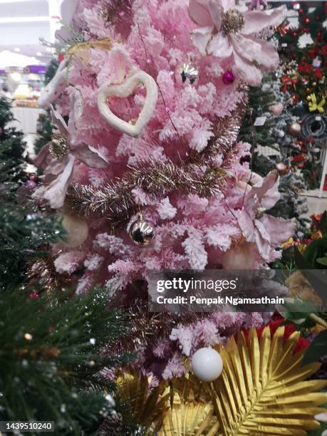 decorated christmas green tree decorations have pine cones red pill, leaves on blurred of background - embellishment stock pictures, royalty-free photos & images