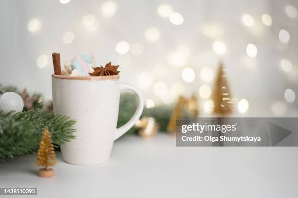 new year's drink cup with decor on the background with bokeh . - christmas coffee imagens e fotografias de stock