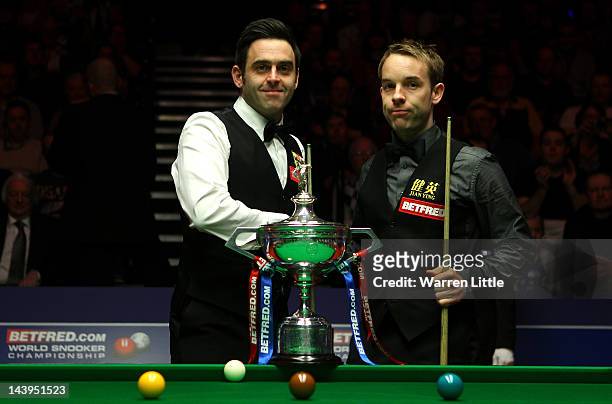 Ronnie O'Sullivan and Allister Carter of England shake hands ahead of the final of the Betfred.com World Snooker Championship at the Crucible Theatre...