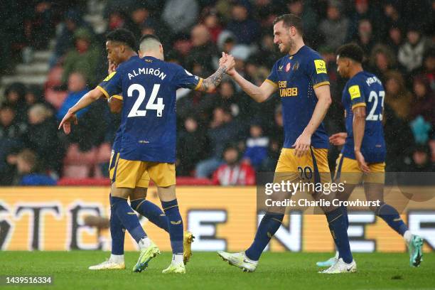 Chris Wood celebrates with Miguel Almiron of Newcastle United after scoring their team's second goal during the Premier League match between...