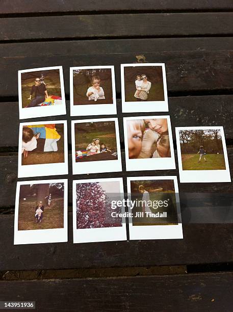 ten polaroids on a picnic bench - group of objects baby stock pictures, royalty-free photos & images