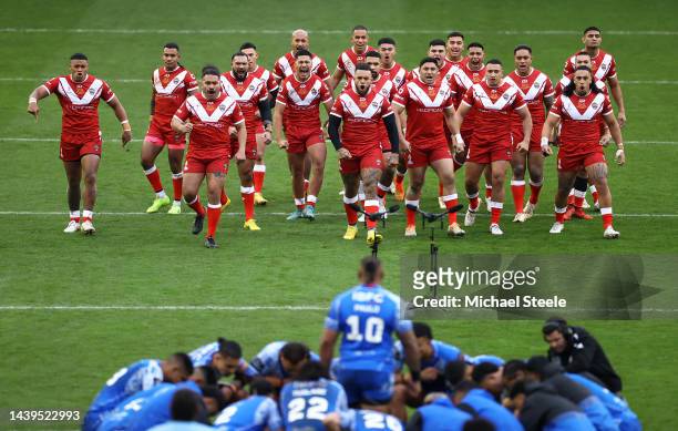 Players of Tonga perform the Sipi Tau and Players of Samoa perform the Siva Tau ahead of the Rugby League World Cup Quarter Final match between Tonga...