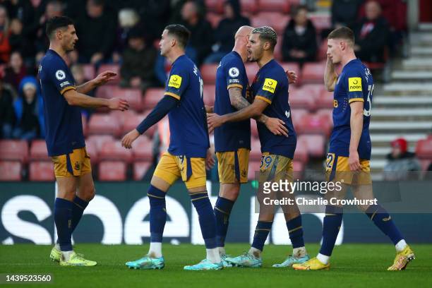 Bruno Guimaraes of Newcastle United celebrates with teammates after scoring their team's fourth goal during the Premier League match between...