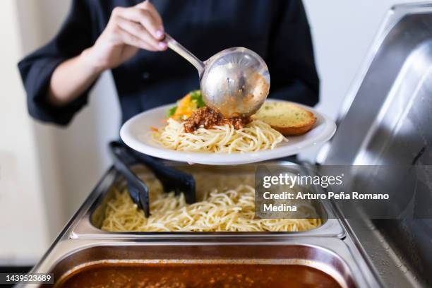 cook serving food on a plate - lunch buffet stock pictures, royalty-free photos & images