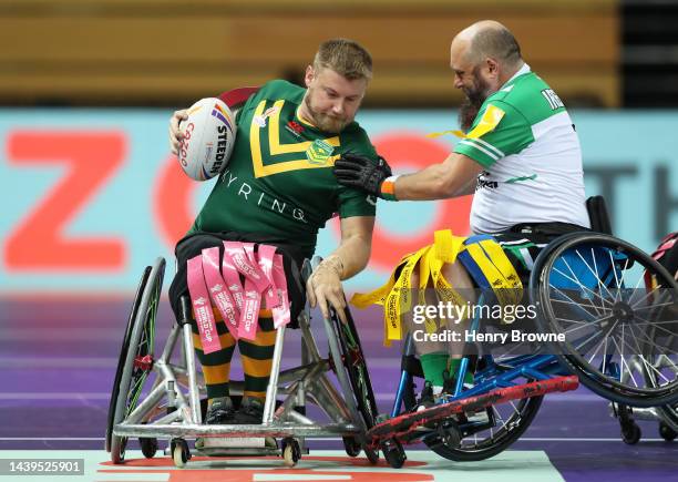 Zac Schumacher of Australia looks to break past Scott Robertson of Ireland during the Wheelchair Rugby League World Cup Group A match between...