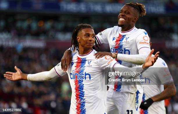 Michael Olise celebrates with Wilfried Zaha of Crystal Palace after scoring their team's second goal during the Premier League match between West Ham...