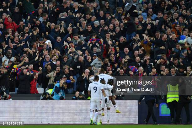 Michael Olise of Crystal Palace celebrates with the fans after scoring their team's second goal during the Premier League match between West Ham...