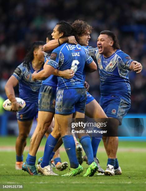 Players of Samoa celebrate on the final whistle following the Rugby League World Cup Quarter Final match between Tonga and Samoa at The Halliwell...