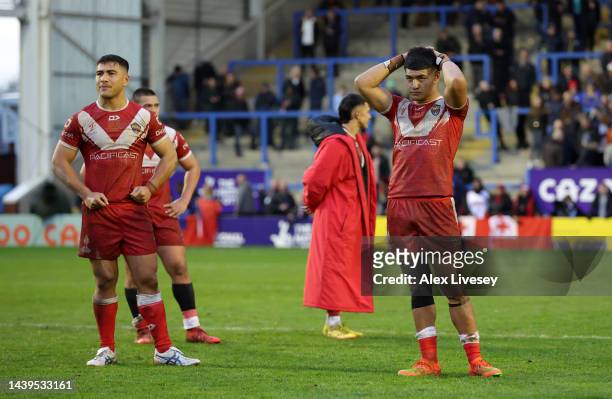 Players of Tonga cut dejected figures following the Rugby League World Cup Quarter Final match between Tonga and Samoa at The Halliwell Jones Stadium...