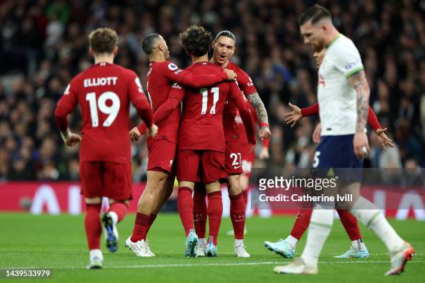 Mohamed Salah of Liverpool celebrates with teammates after scoring their team's first goal during the Premier League match between Tottenham Hotspur...