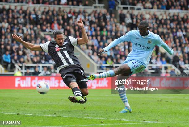 Yaya Toure of Manchester City scores to make it 2-0 under pressure from Jonas Gutierrez of Newcastle United during the Barclays Premier League match...