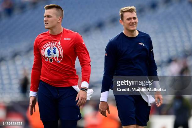 Bailey Zappe and Mac Jones of the New England Patriots warm up before a game against the Indianapolis Colts at Gillette Stadium on November 06, 2022...