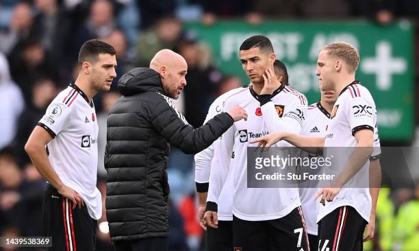 Cristiano Ronaldo of Manchester United listens as manager Erik ten Hag gives instructions in the centre circle of the pitch prior to the second half...