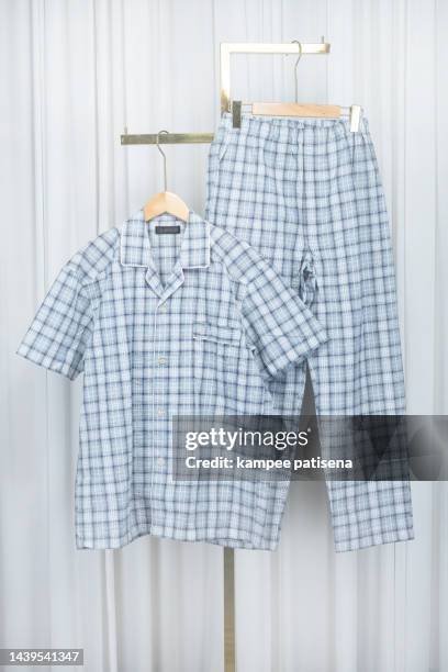 pajamas hanging in home - silk pajamas stock pictures, royalty-free photos & images