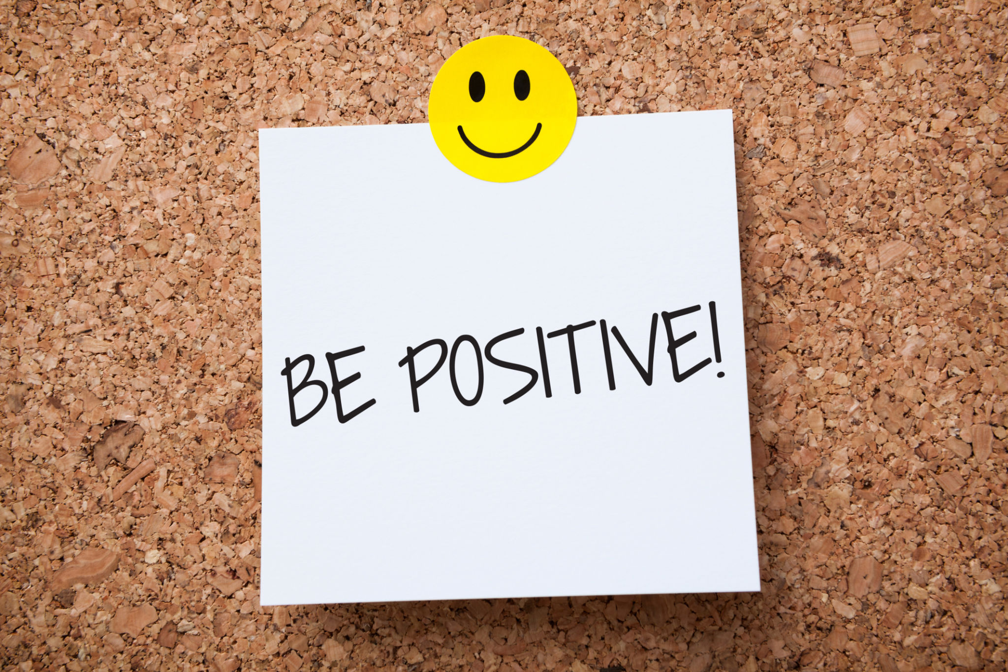 White Sticky Note With Be Positive And Red Push Pin On Cork Board White Sticky Note With Be Positive And Red Push Pin On Cork Board