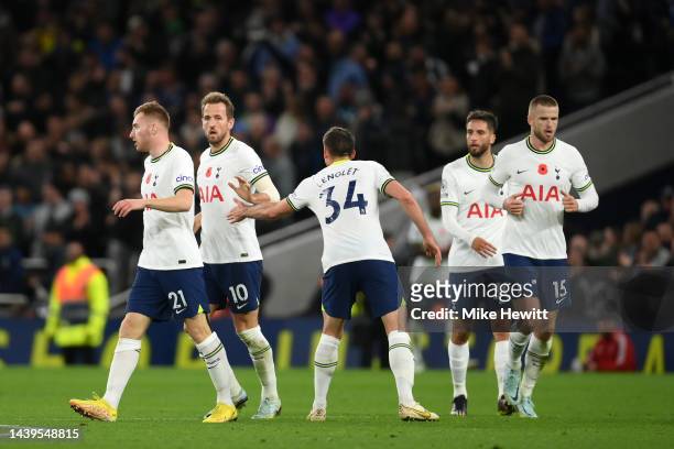 Harry Kane of Tottenham Hotspur celebrates with teammates after scoring their team's first goal during the Premier League match between Tottenham...