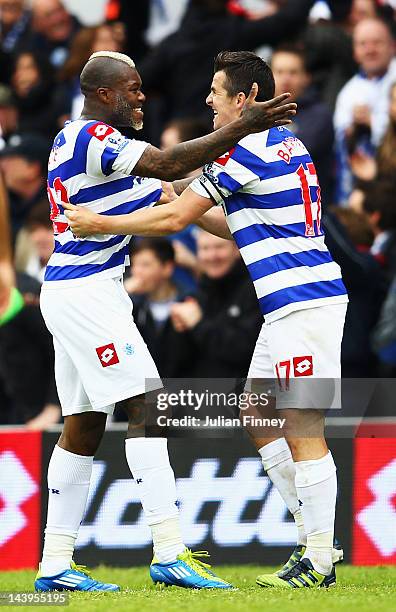 Djibril Cisse of Queens Park Rangers celebrates with team mate Joey Barton after scoring during the Barclays Premier League match between Queens Park...